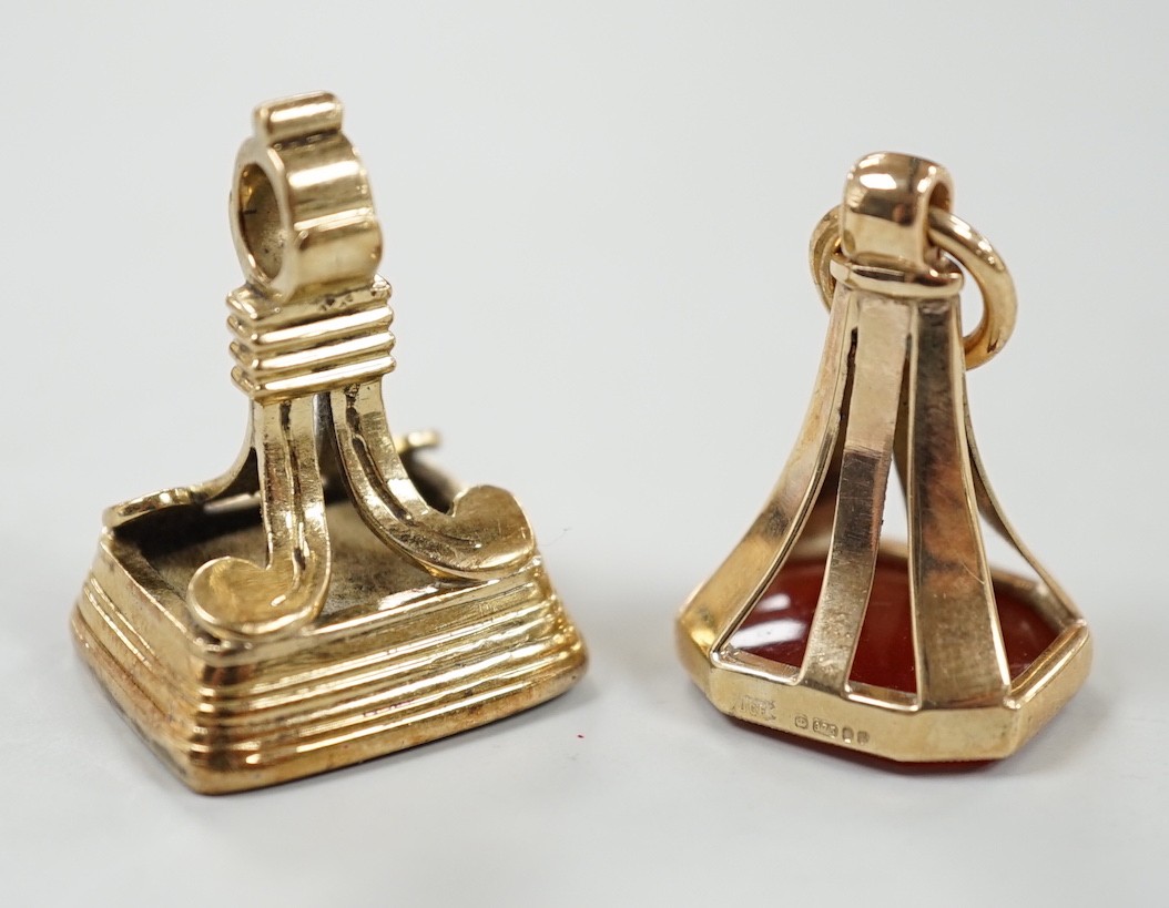 A 19th century yellow metal overlaid and white carnelian set fob seal, the matrix carved with the letter K, 27mm and a 1970's 9ct gold and carnelian set fob seal, the matrix carved with an armorial.